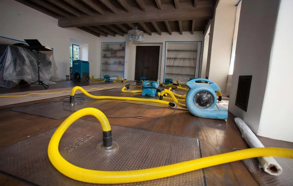 Water extraction equipment drying a flooded Tauranga room