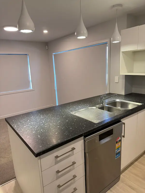 Professionally cleaned kitchen island and sink during bond clean in Tauranga rental property