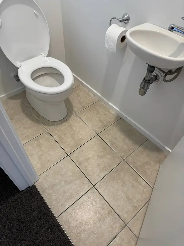 Professionally cleaned toilet and tiled bathroom floor during bond clean in Tauranga