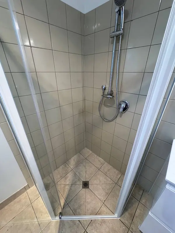 Clean shower with restored tile and grout after professional tenancy cleaning in Tauranga