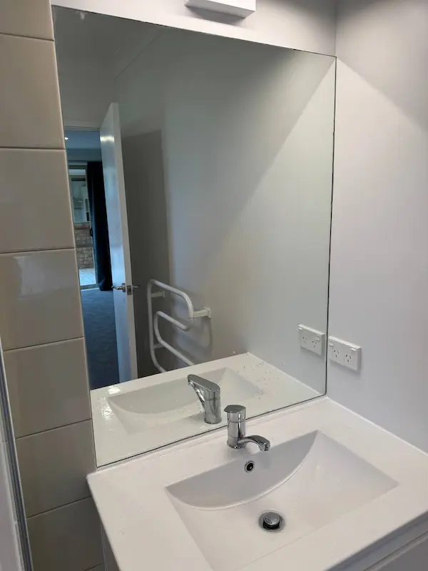 Streak-free bathroom vanity and mirror after rental property cleaning in Tauranga