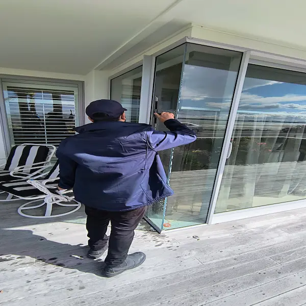 Professional window cleaner achieving streak-free results in Tauranga